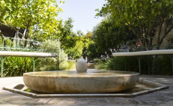 A marble water feature bowl in the covered central feature of the Islamic section in The Secret Garden, Le Jardin Secret, in the Medina district of Marrakech, Morocco.