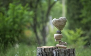 A big balance with a rock on the top